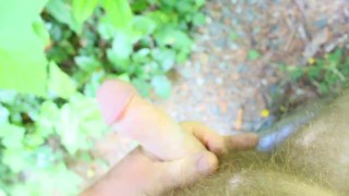 Guy jacking of and cums on a leaf outdoors