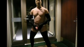 stocking masked biker jerks off in hotel hall