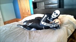 Skeleton against stocking masked wetsuited frogman