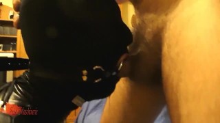 Masked, cuffed, ring gagged slut in black PVC deepthroated