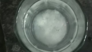 Dude cumming in a glass of water