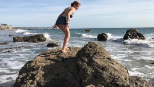 Model blows on the beach