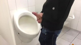 Gay boy is jerking off in public restroom and shoot his load in a urinoir