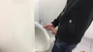 Gay boy is jerking off in public restroom and shoot his load in a urinoir