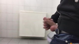 Gay boy is jerking off in public restroom and shoot his load in a urinoir