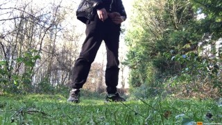 boy is urinating in the woods