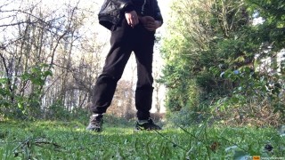 boy is urinating in the woods