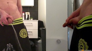 teen boy is urinating in the bathroom