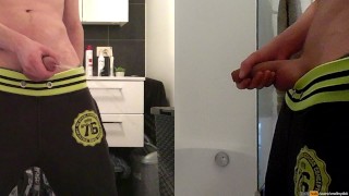 teen boy is urinating in the bathroom