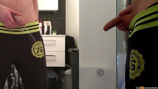 teen boy is urinating in the bathroom