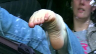 Bare feet against windshield