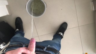 boy peeing in a bucket