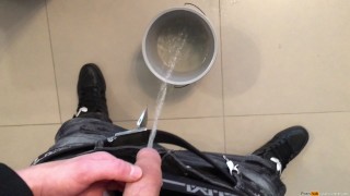 boy peeing in a bucket