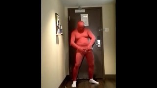 red morphsuit jerking off at hotel room door