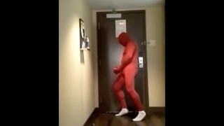 red morphsuit jerking off at hotel room door