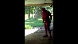 red zentai jerking off at garage door