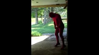 red zentai jerking off at garage door