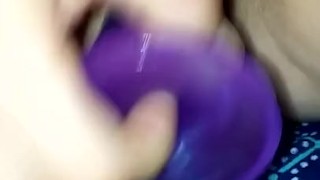 Masturbating with purple dildo