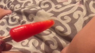 Milf rubs pussy with pop sickle then deep throats it