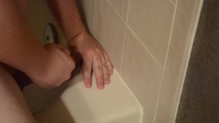Shaved twink practices deepthroating in the shower
