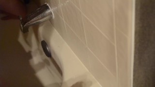 Shaved twink practices deepthroating in the shower