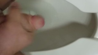 Jerking off in a public toilet