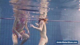 Horny girls strip eachother in the pool