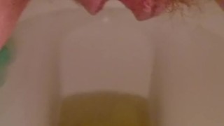 Close up hairy pussy piss and rub on toilet