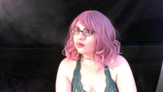 Coco smoking with pink hair and glasses
