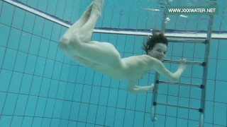 Podvodkova swimming in blue bikini in the pool
