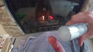 Young guy jerks off in front of fireplace on a cold day