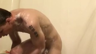 Sexy guy strokes it in shower