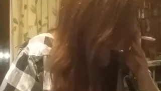 Sexy redhead smoking with tits out fetish play