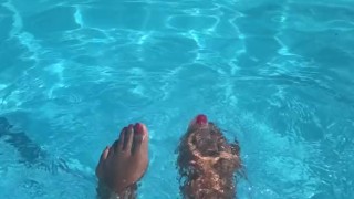 Ebony splashes her feet in the pool.