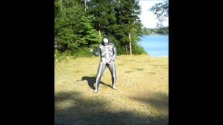 armed zentai skeleton outdoors in the sun