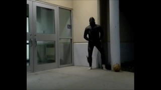 barefoot frogman cums inside a condom in front of hotel doors