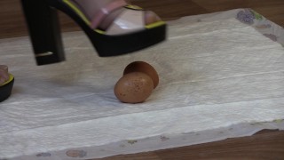 crashes eggs with high heels, mature lady in high-heeled shoes