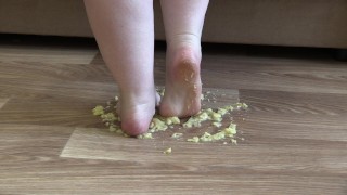 MILF crushes a banana bare feet
