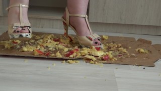 Crush fetish. Puffy legs in high-heeled shoes trample on apples.