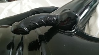 Close-up latex cock and mask