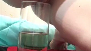 Norma over flows a vase with pee