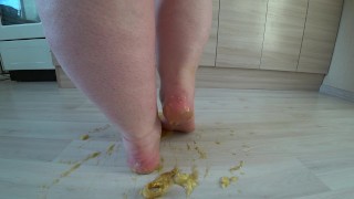a big mature woman, bbw, smash a banana with bare feet, heels. crash trampl