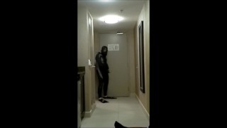 wearing wetsuit and fins shoot a quick load at open hotel door
