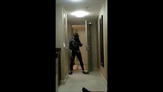 wearing wetsuit and fins shoot a quick load at open hotel door