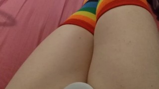 Weak femboy in pink schoolgirl uniform and rainbow gloves & stockings cums