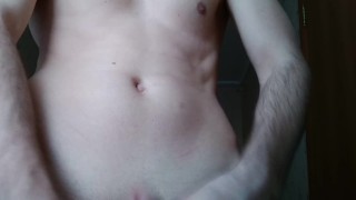 Fit man jerks off while watching porn, cums onto his own cock
