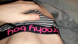 Twink plays with dick through briefs in bed