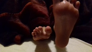 Lubed feet and soles rubbing each other - spreading toes