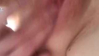 Pierced blonde fingers herself on bed