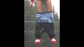 Teen shows his big cock for fun on a trampoline at the camp